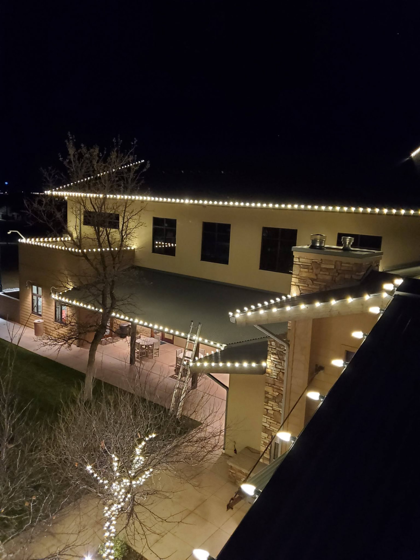 Desert home lit with crisp white Christmas lights