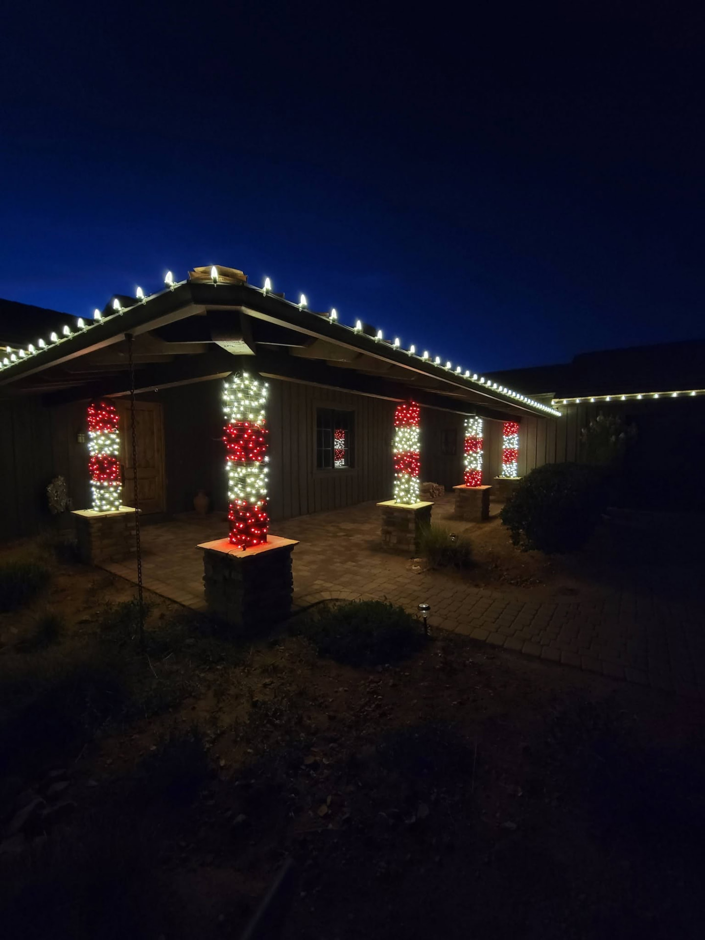 Home with holiday lights along the eaves