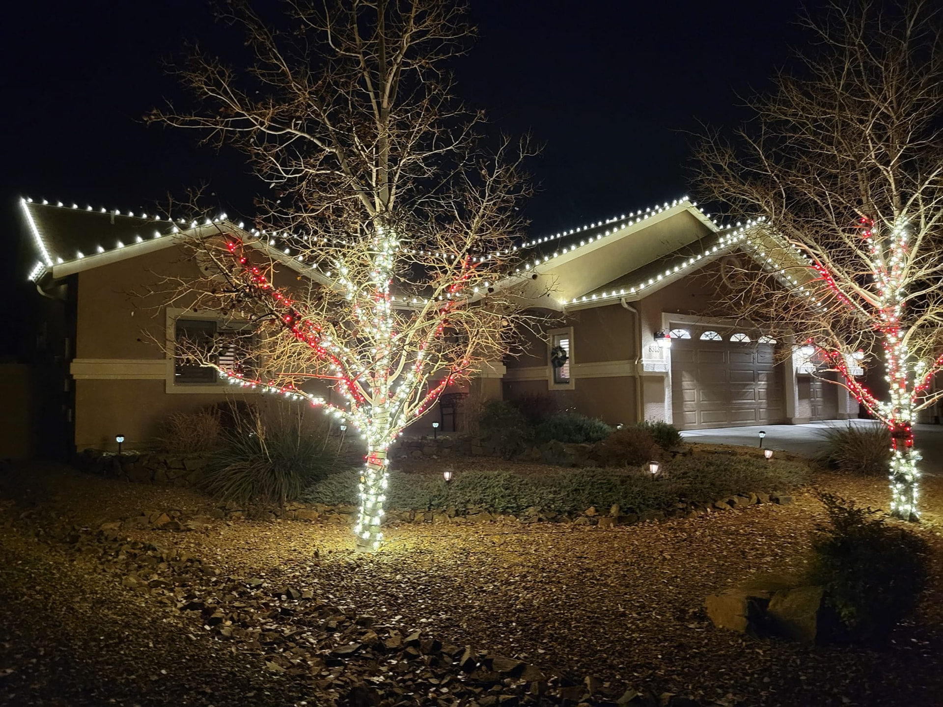Home outlined in warm white Christmas lights