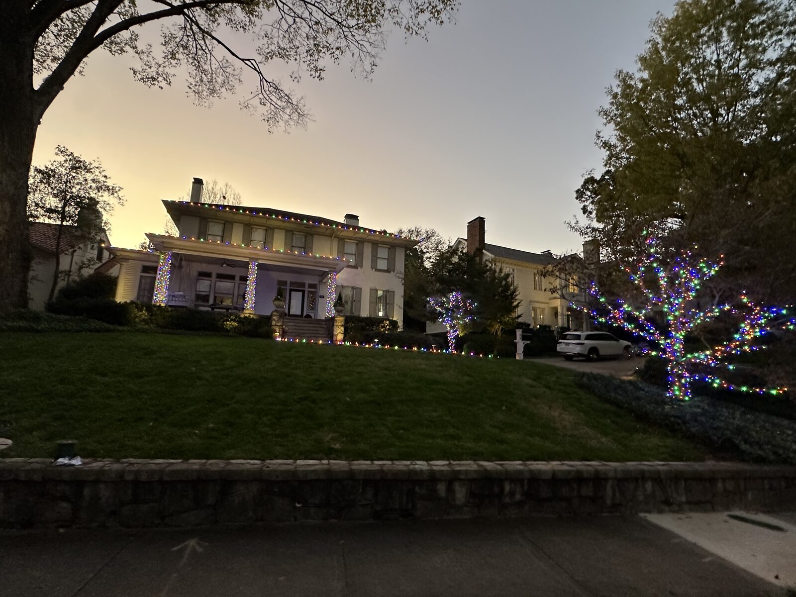 Two-story home with peaks outlined in lights