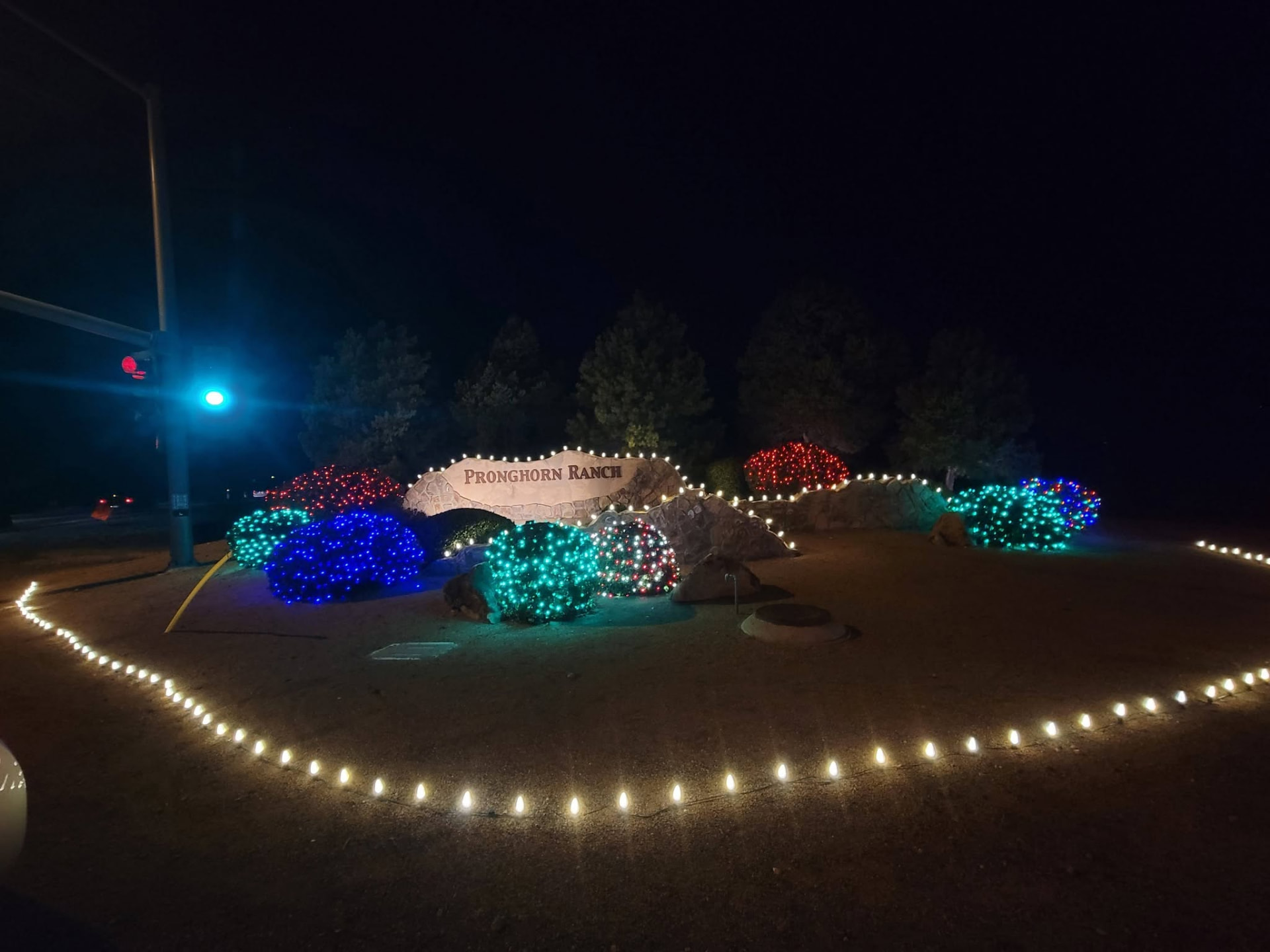 Home with lighted wreath and roofline lights
